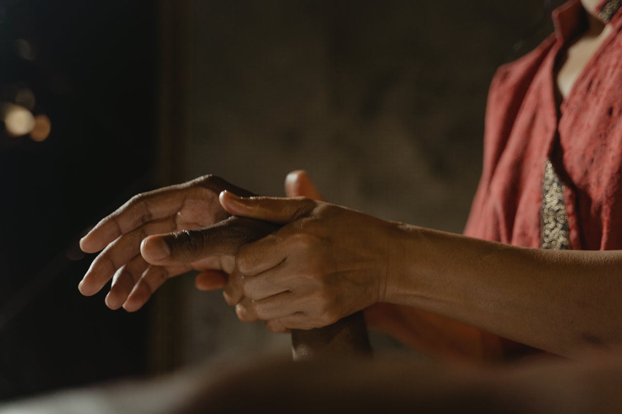 Close-up of a hand massage in a soothing spa environment, focusing on relaxation and therapy.